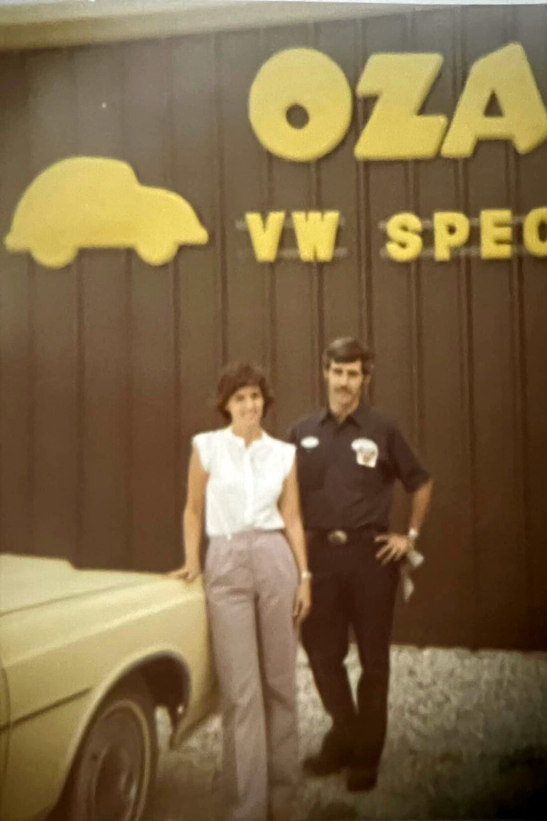 Early Ozark Import Specialists founders standing in front of the original OZA VW Specialists shop.